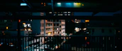 Evening cityscape of Cusco seen from a balcony with warm ambient lighting.