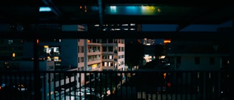 An urban skyline view from an apartment balcony.
