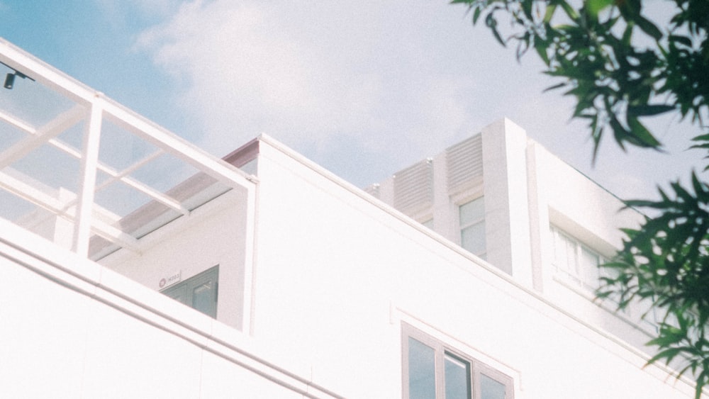 a white building with a clock on the top of it