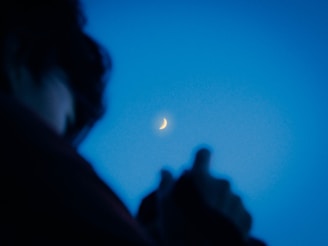 A serene image of a whirling dervish silhouette against a soft moonlit background.