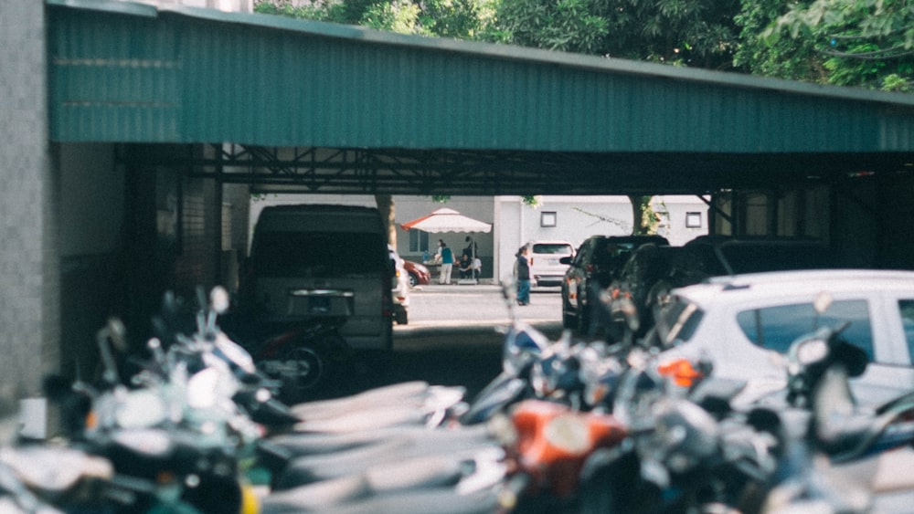 a group of motorcycles parked under a bridge