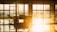 A bright and clean office environment with sunlight streaming through large windows.