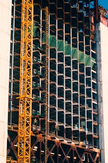 a large crane is standing in front of a building