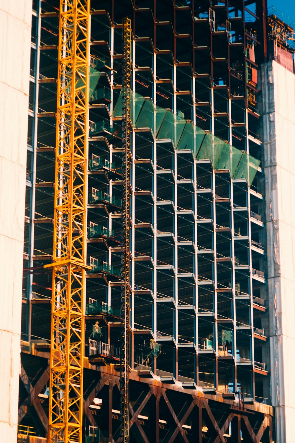 a large crane is standing in front of a building