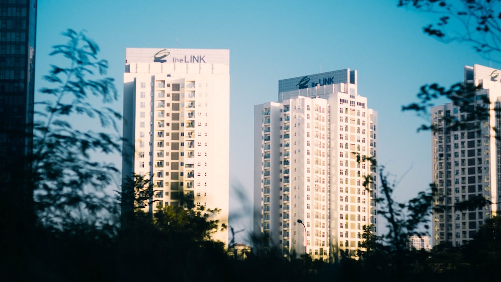 a couple of tall buildings sitting next to each other