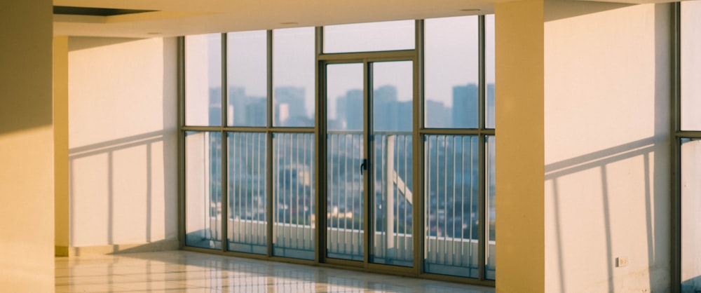 an empty room with a view of a city