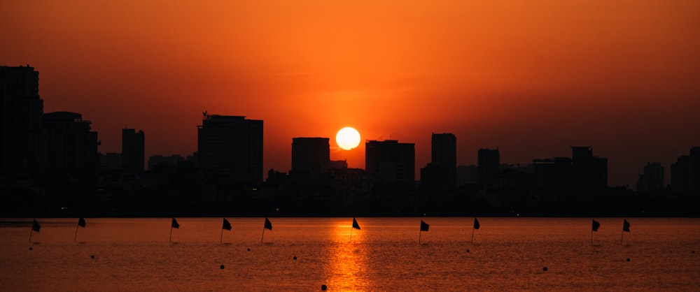 a large body of water with a sunset in the background