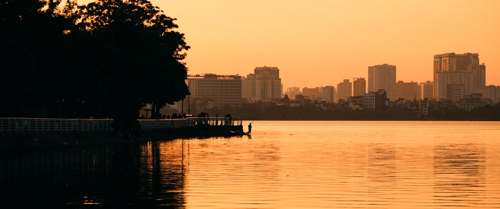 a body of water with a city in the background