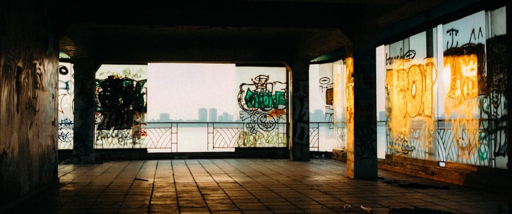 an empty room with graffiti on the walls