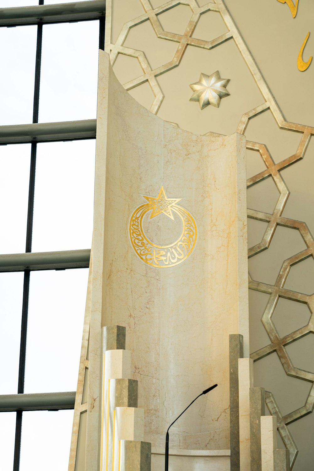 a tall white pillar with a gold emblem on it