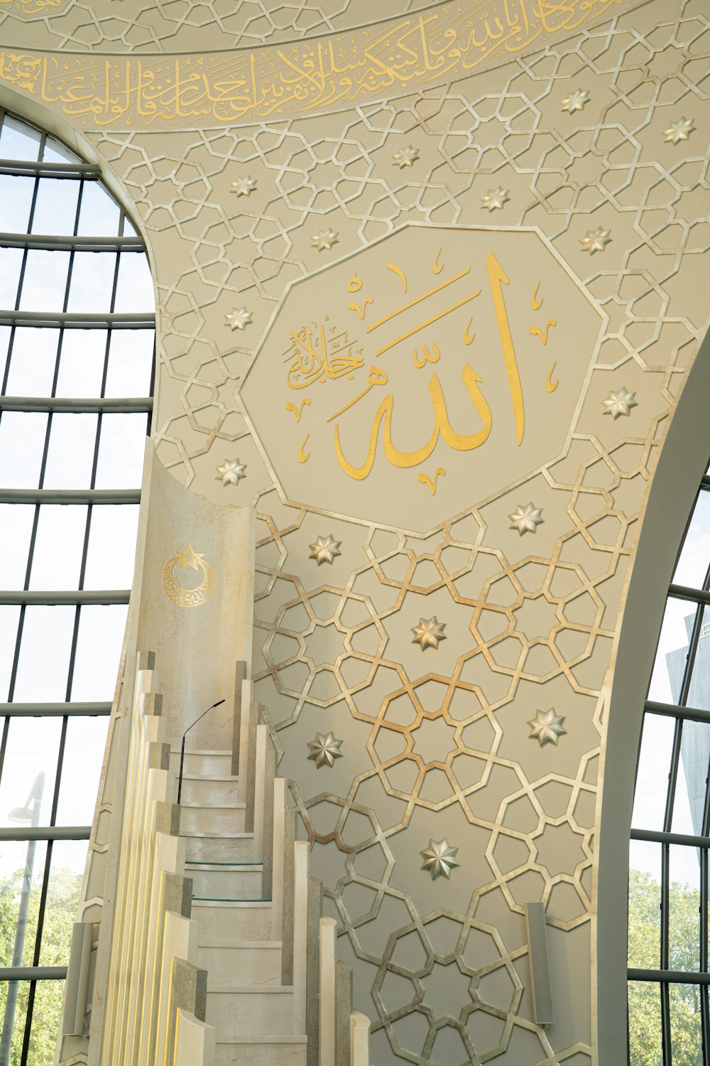 a staircase in a building with arabic writing on the wall