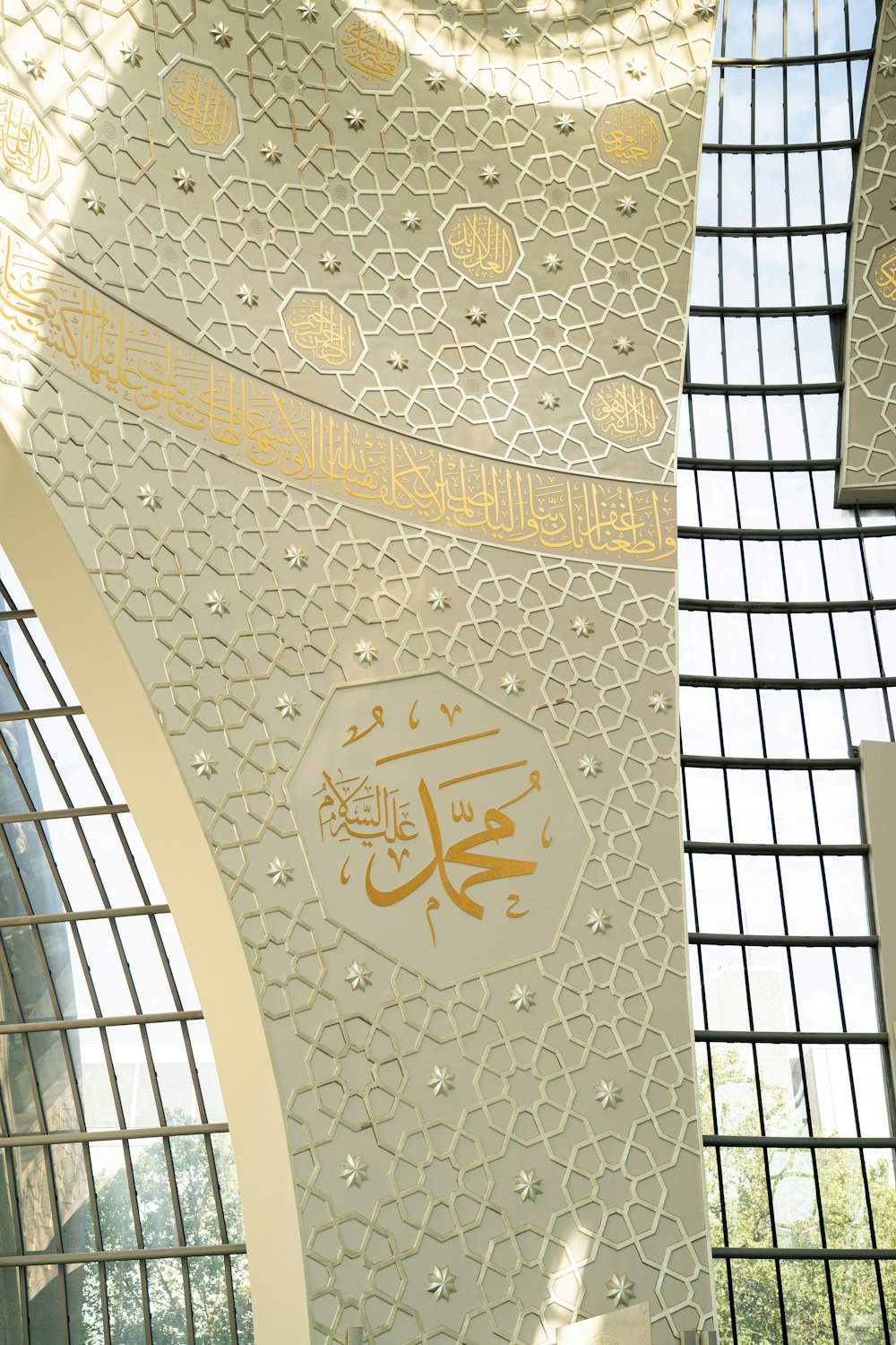 the ceiling of a building with a clock on it