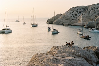 a group of boats floating on top of a body of water