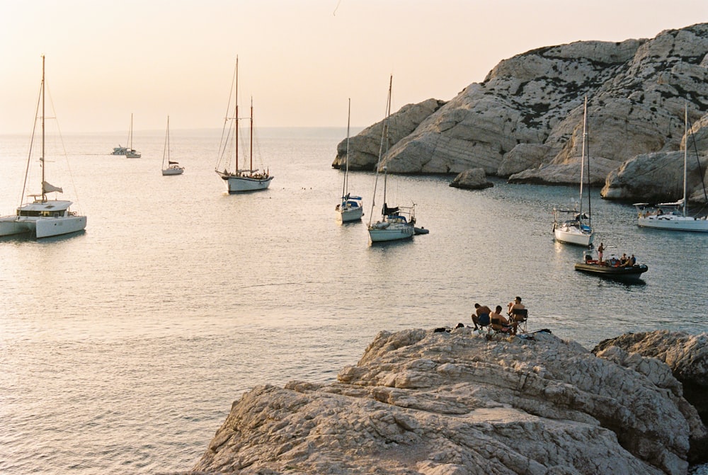 a group of boats floating on top of a body of water