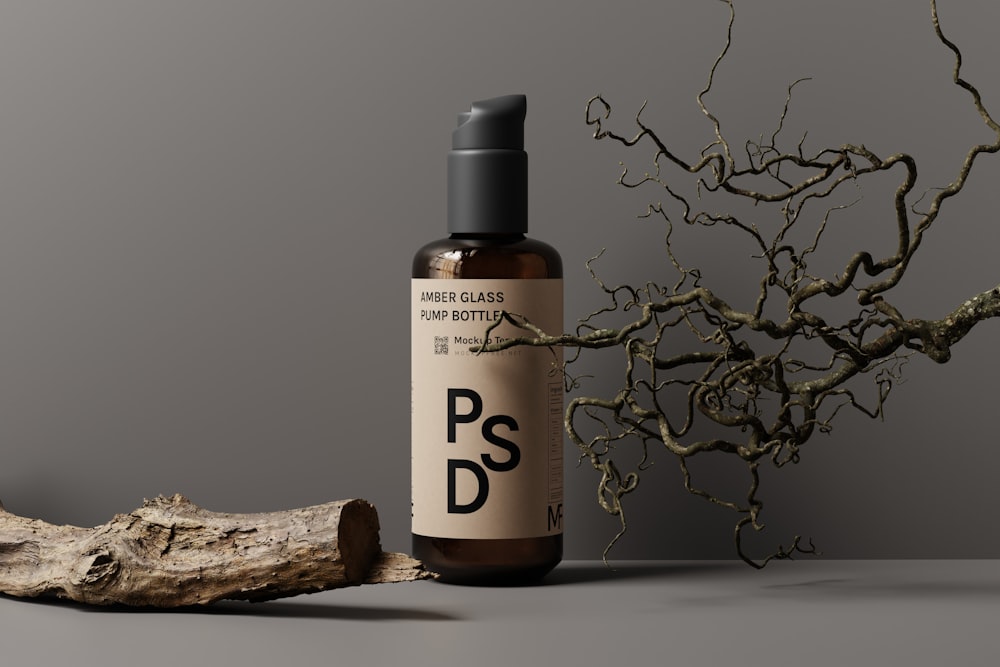 a bottle of psd next to a tree branch