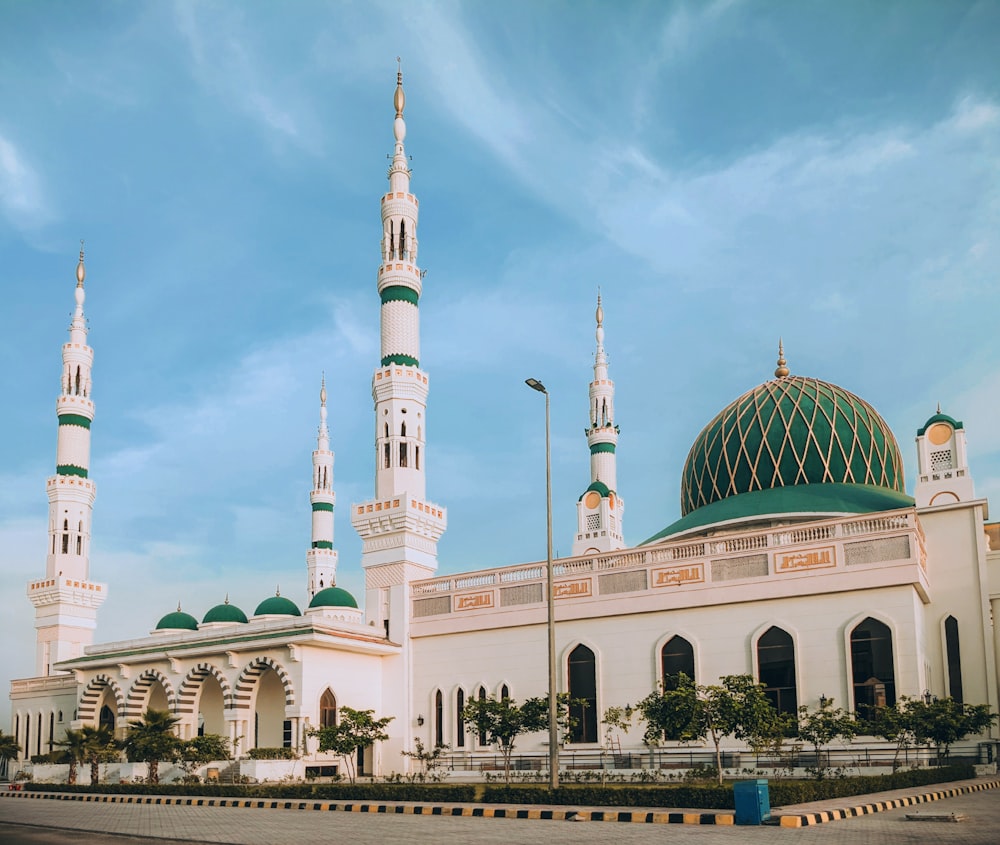 a large white building with a green dome