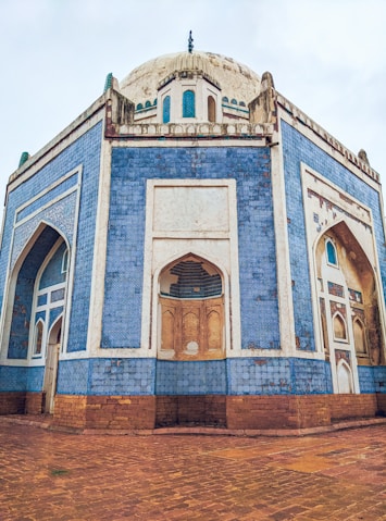 a blue and white building with a clock on top of it