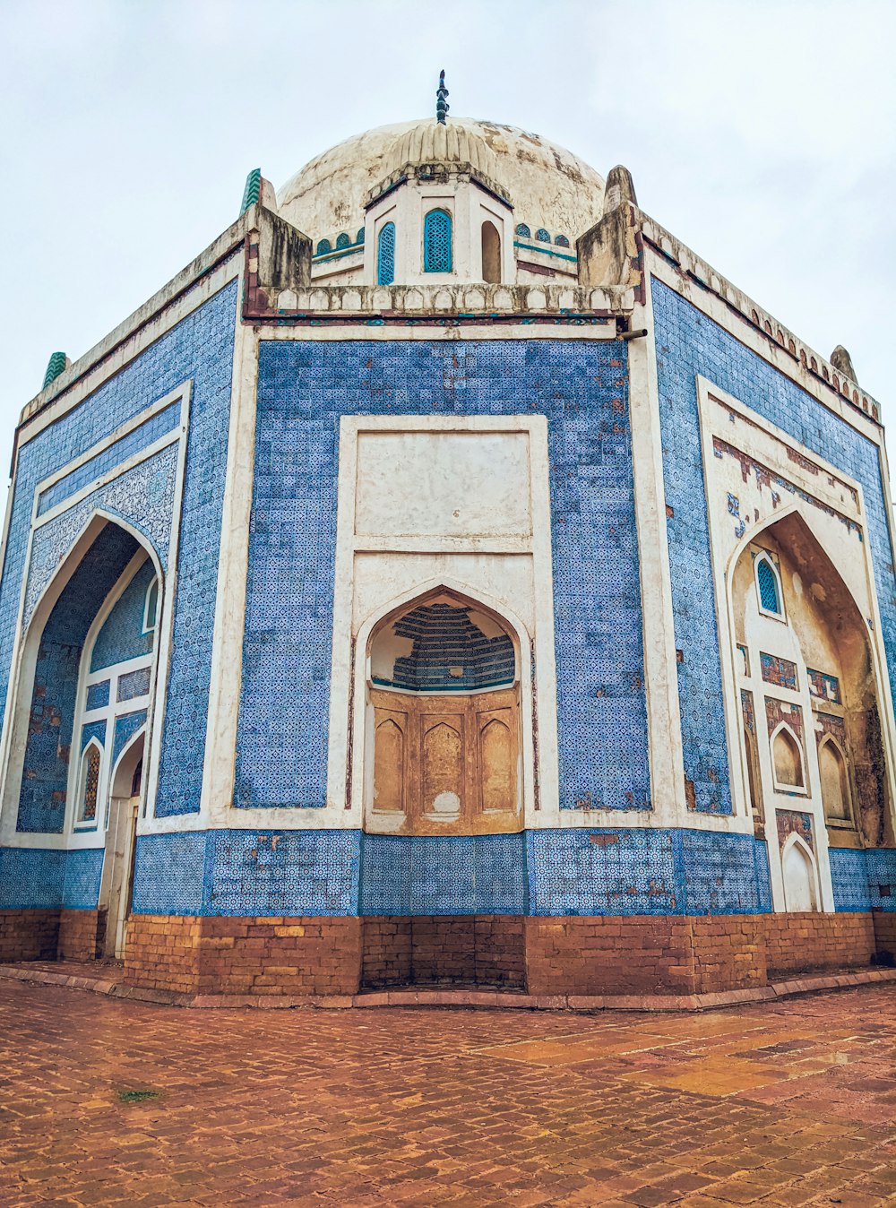 a blue and white building with a clock on top of it