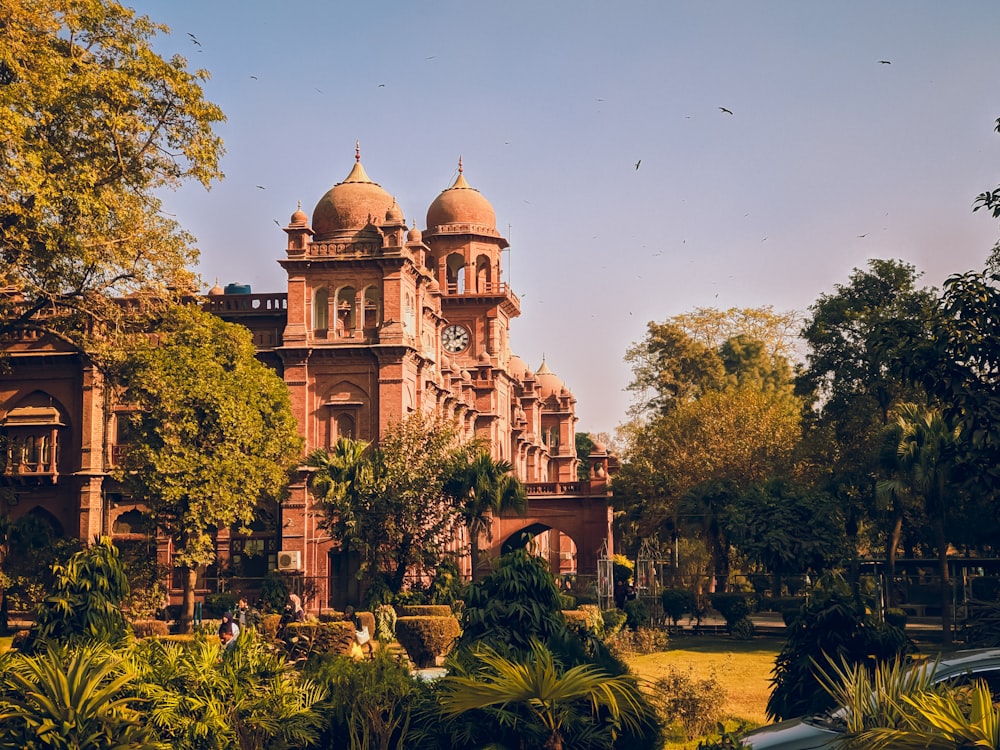 a large building surrounded by trees and plants