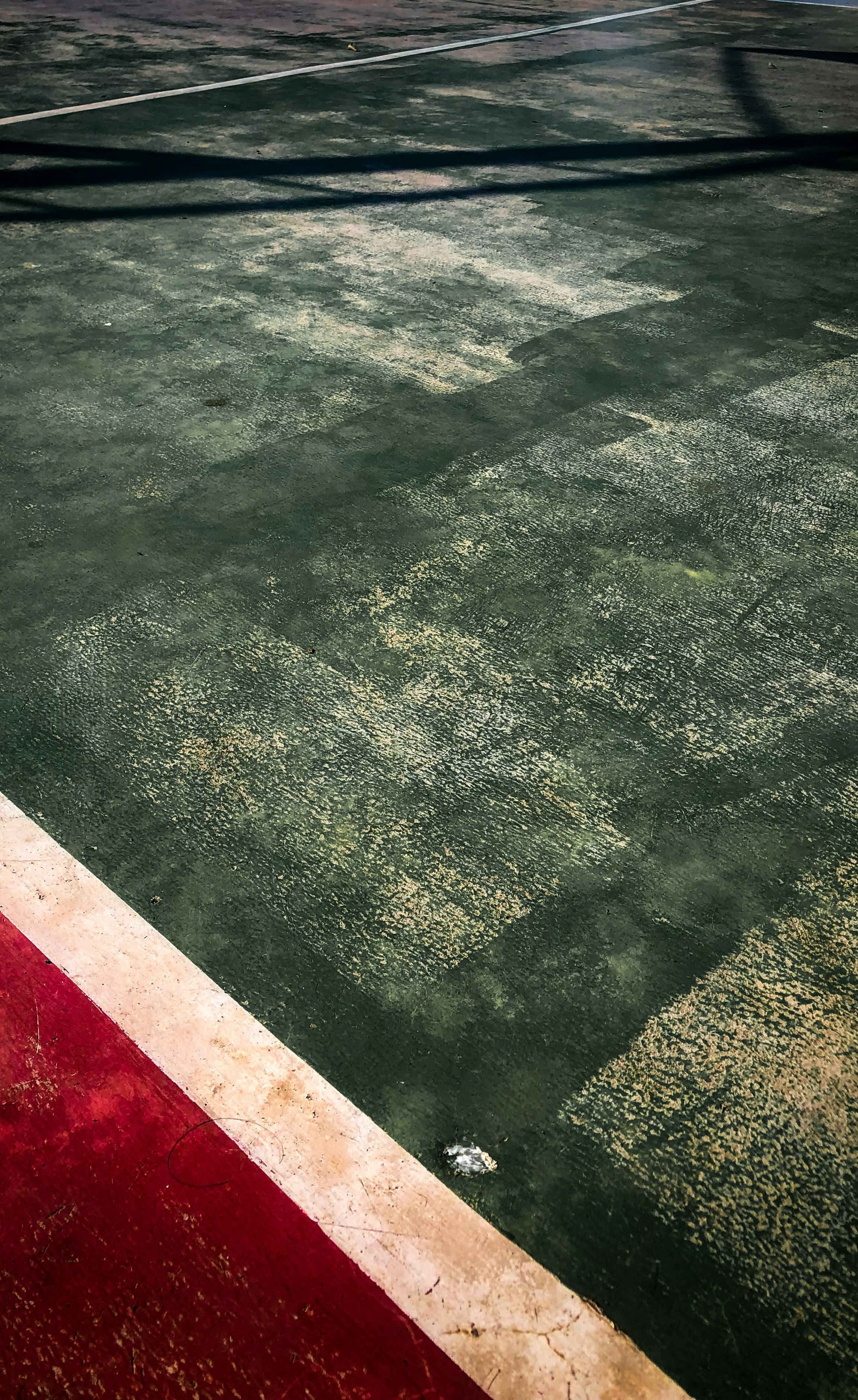 a tennis court with a red and white line
