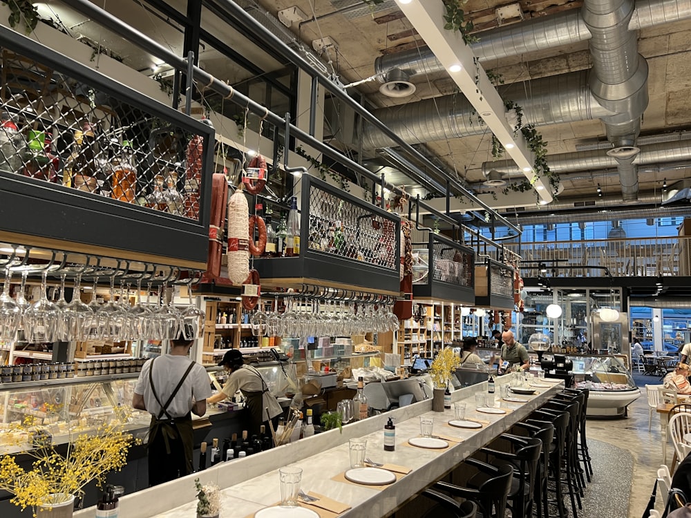 a bar with a lot of bottles and glasses on it