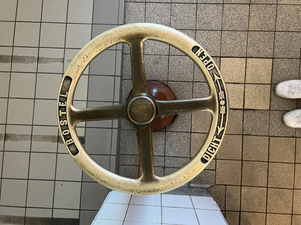 a close up of a steering wheel on a tiled wall