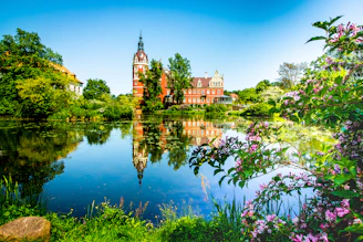 A serene photograph of the foundation's historic building surrounded by lush greenery, reflecting heritage and calm.