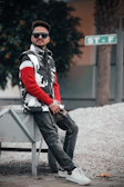 Casual street scene with a person sporting nevrsettlin layered outfits and sneakers.
