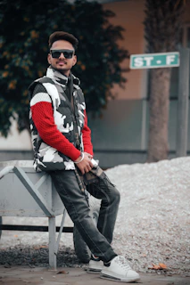 Casual wear ensemble including a cozy knit sweater and relaxed-fit trousers, styled with simple sneakers on a city sidewalk.