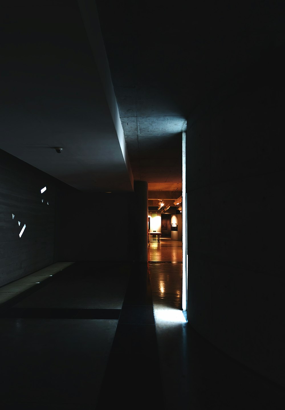 a dimly lit hallway in a dark room