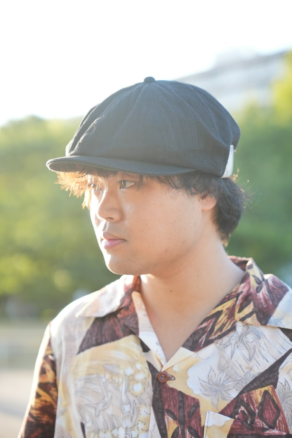 a young man wearing a hat and a shirt