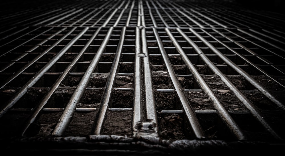 a metal grate that is laying on the ground