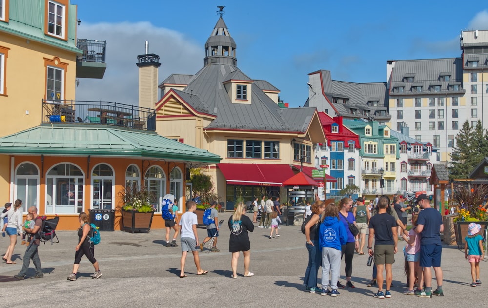 a group of people walking around a town square