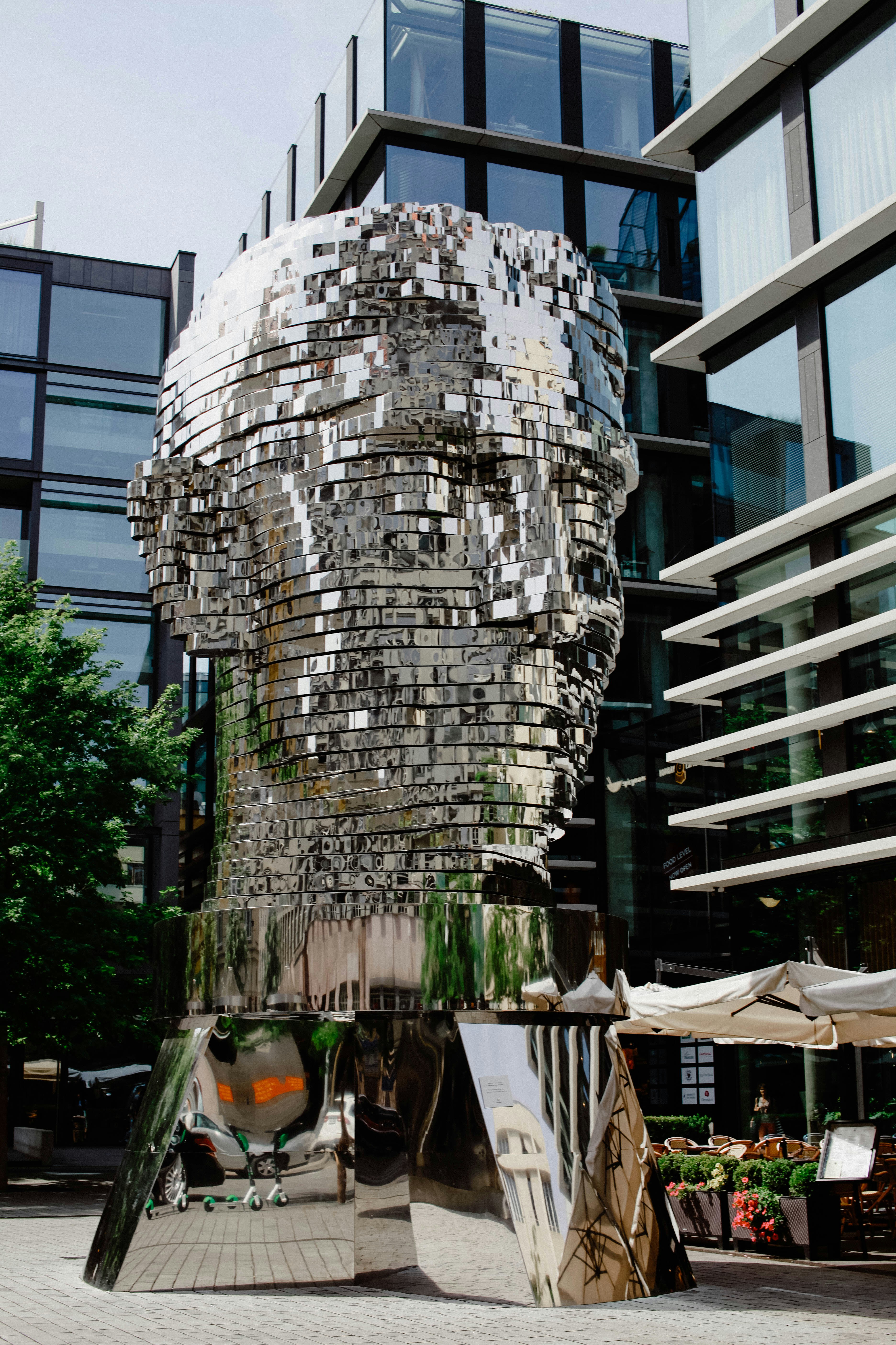 a sculpture of a man's head in front of a building