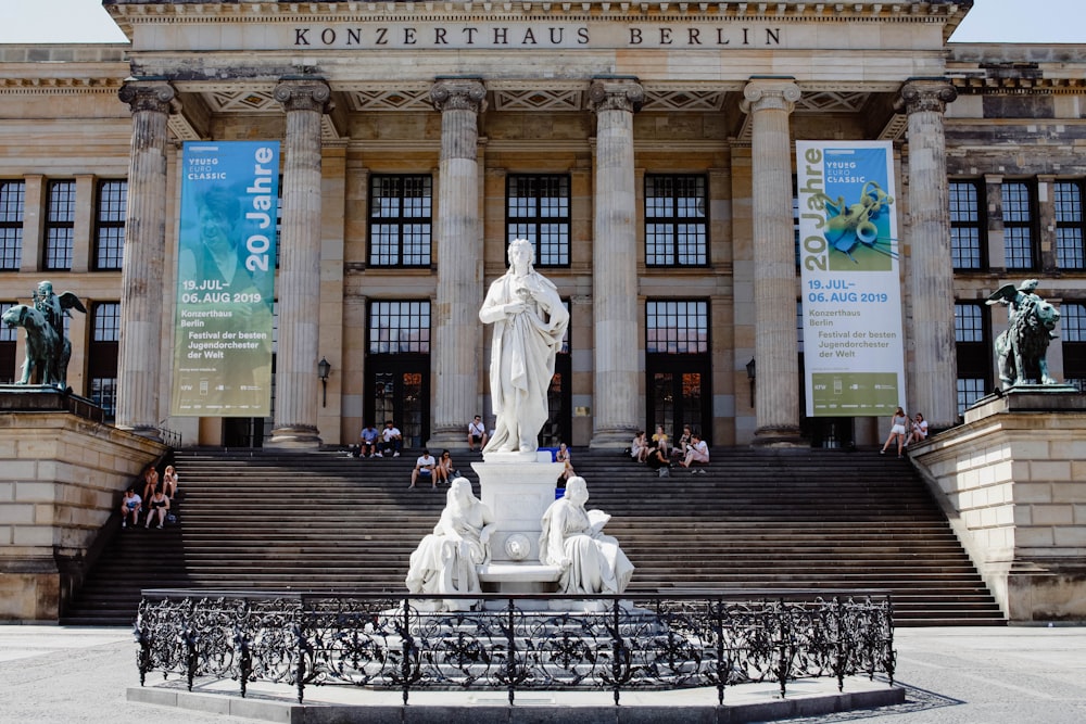 a large building with a statue in front of it