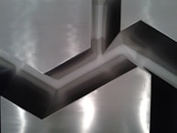 Close-up of an asymmetrical digital composition with high contrast and reflective metallic finishes.