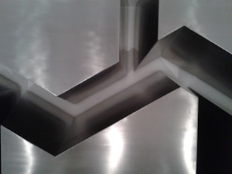 Close-up of an asymmetrical digital composition with high contrast and reflective metallic finishes.