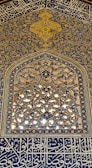 A vibrant Islamic pattern artwork displayed on a wall.