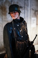 Military-grade protective vests displayed on mannequins in a showroom.