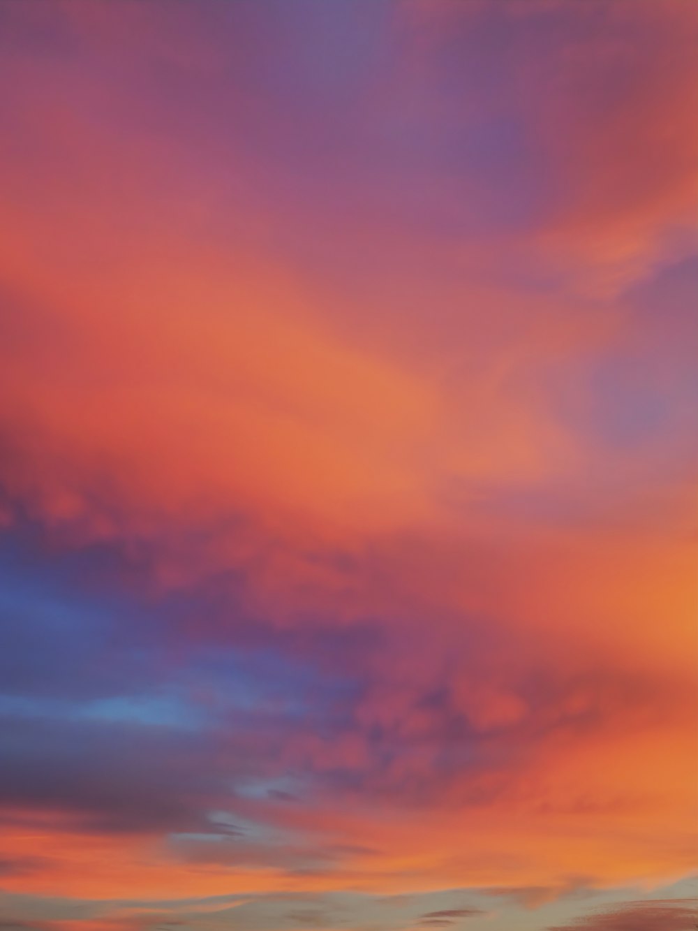 a red and blue sky with some clouds