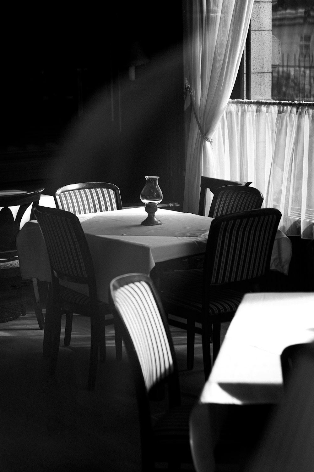 a black and white photo of a table and chairs