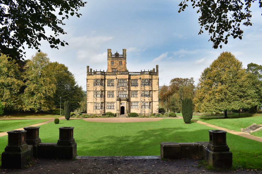 a large building sitting on top of a lush green field