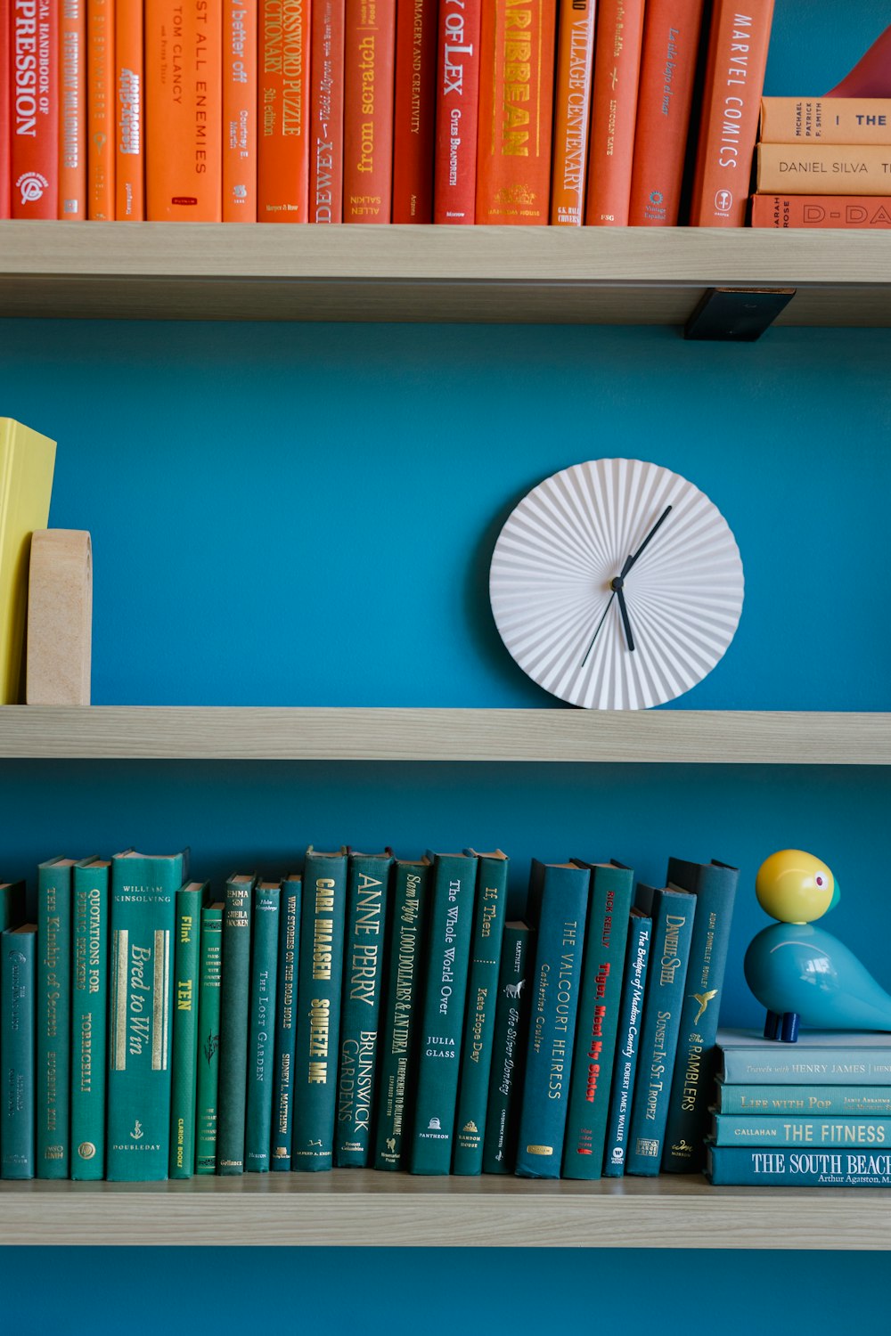 a bookshelf filled with books and a clock