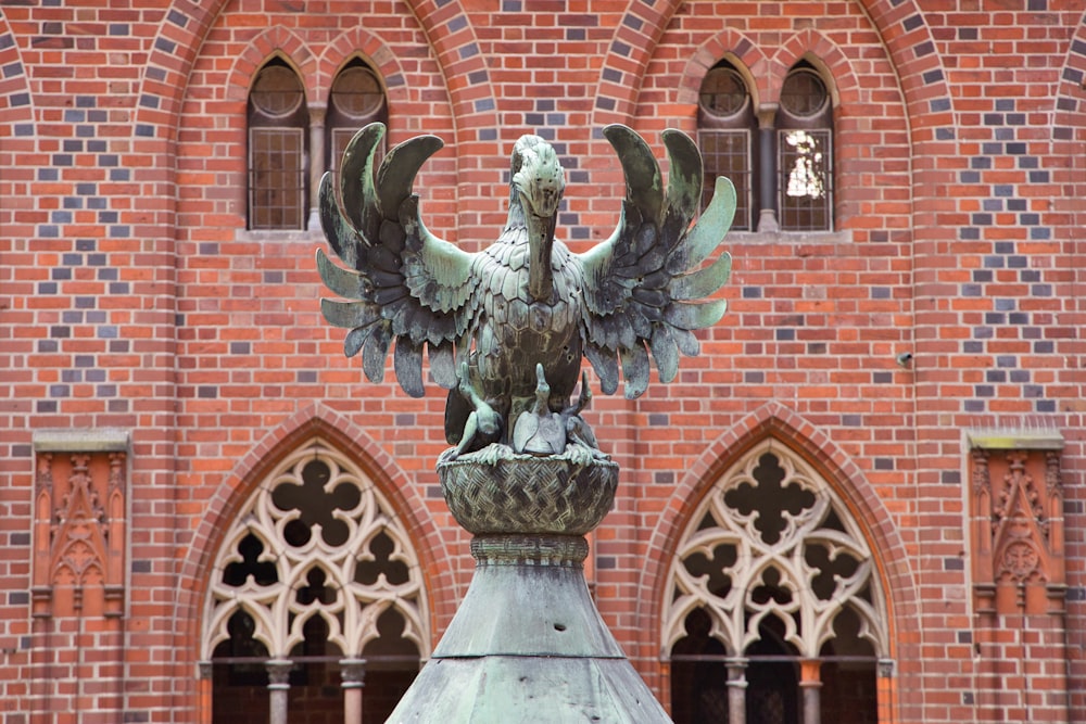 a statue of a bird on top of a building