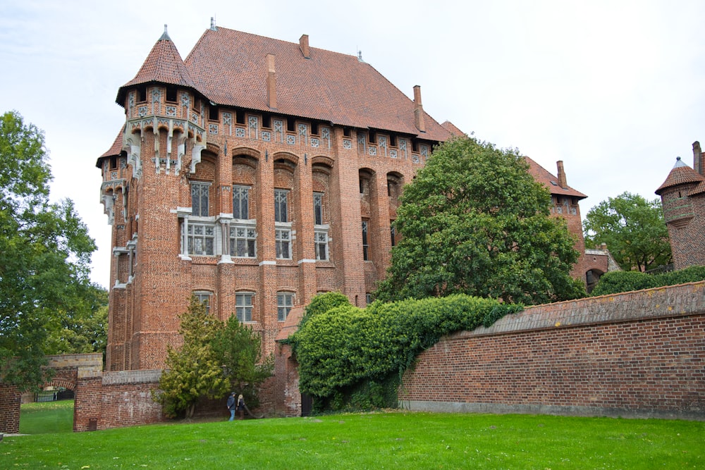 a large brick building with a tall tower