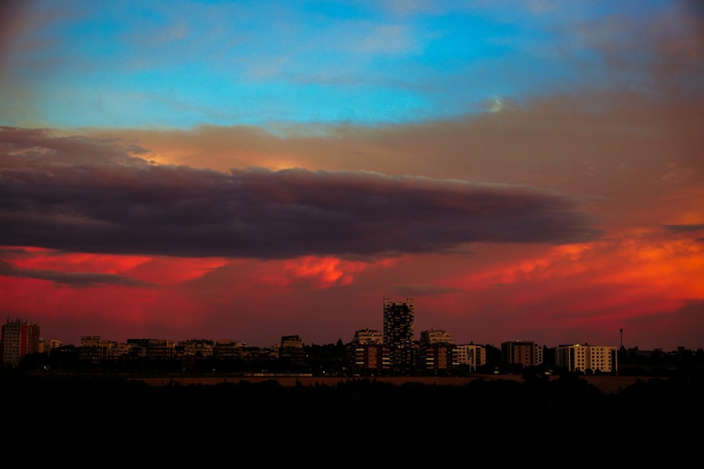 a red and blue sky over a city
