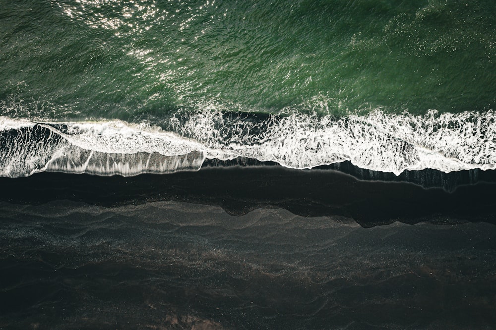 an aerial view of the ocean with waves