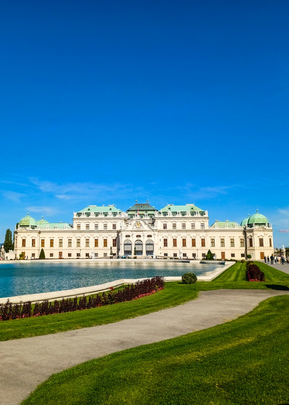 a large white building with a fountain in front of it