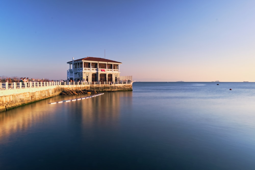 a building sitting on the side of a body of water