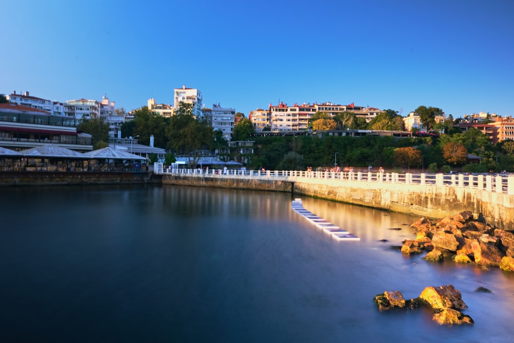 a body of water with a city in the background